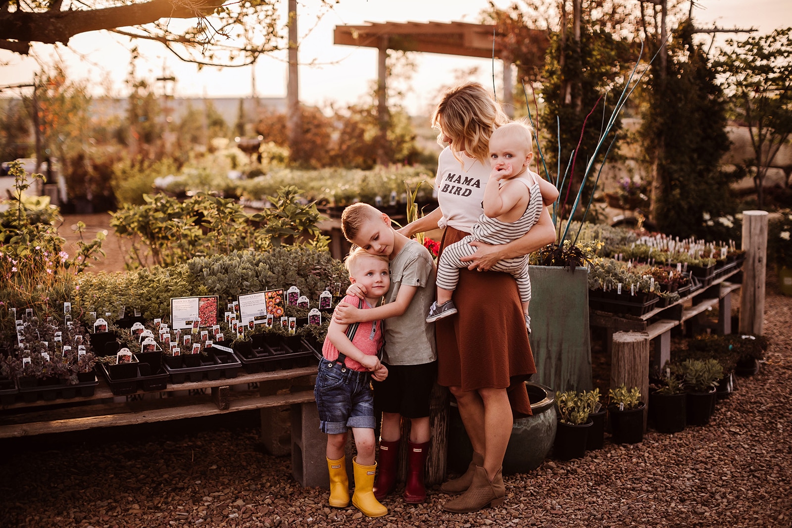 portrait of mother with three sons at a plant nursery