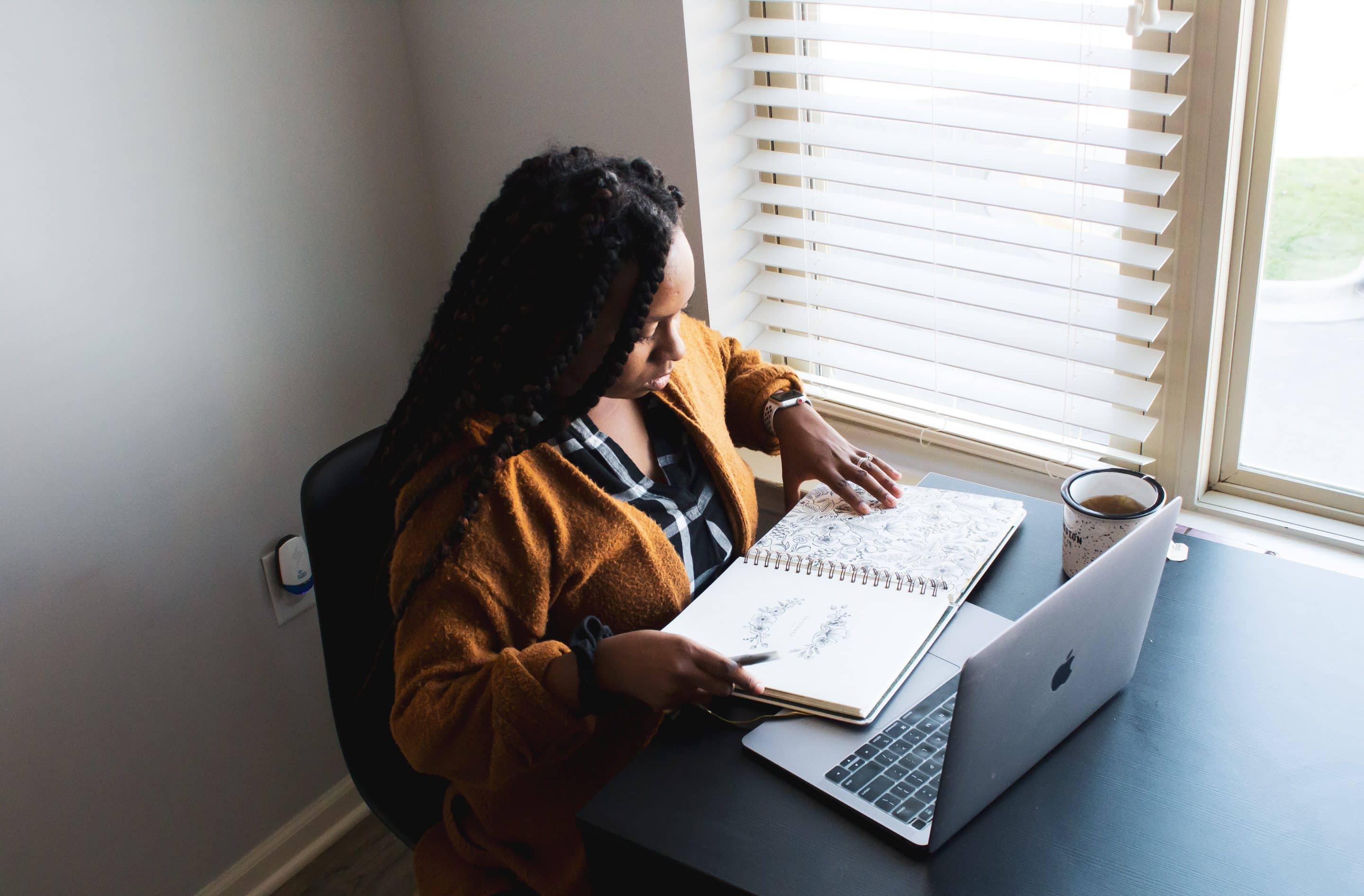image of woman at desk with planner and laptop from unsplash.com